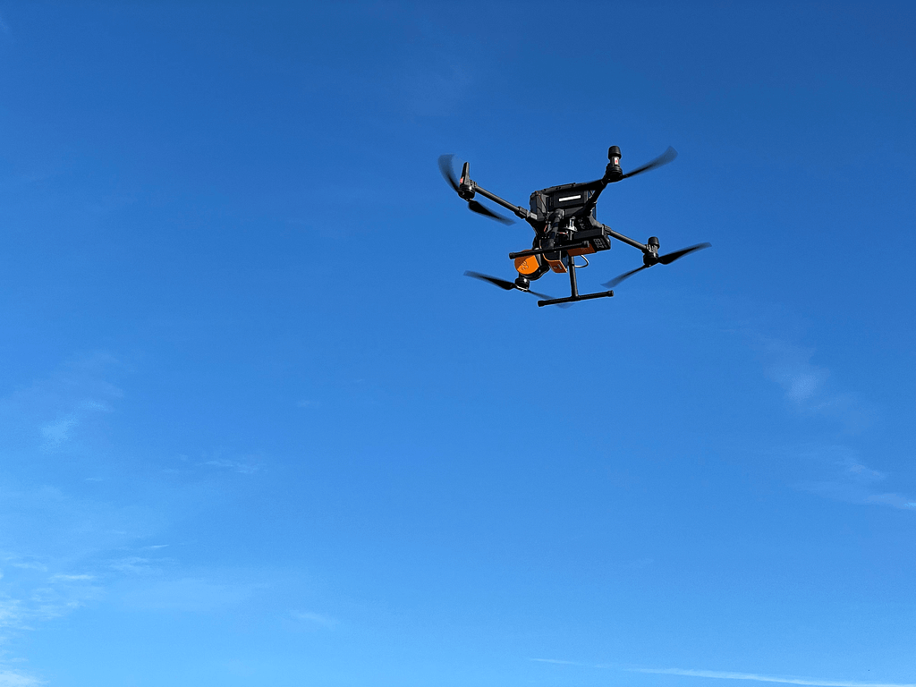 The image depicts a drone in flight.