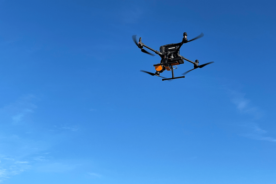 The image depicts a drone in flight.